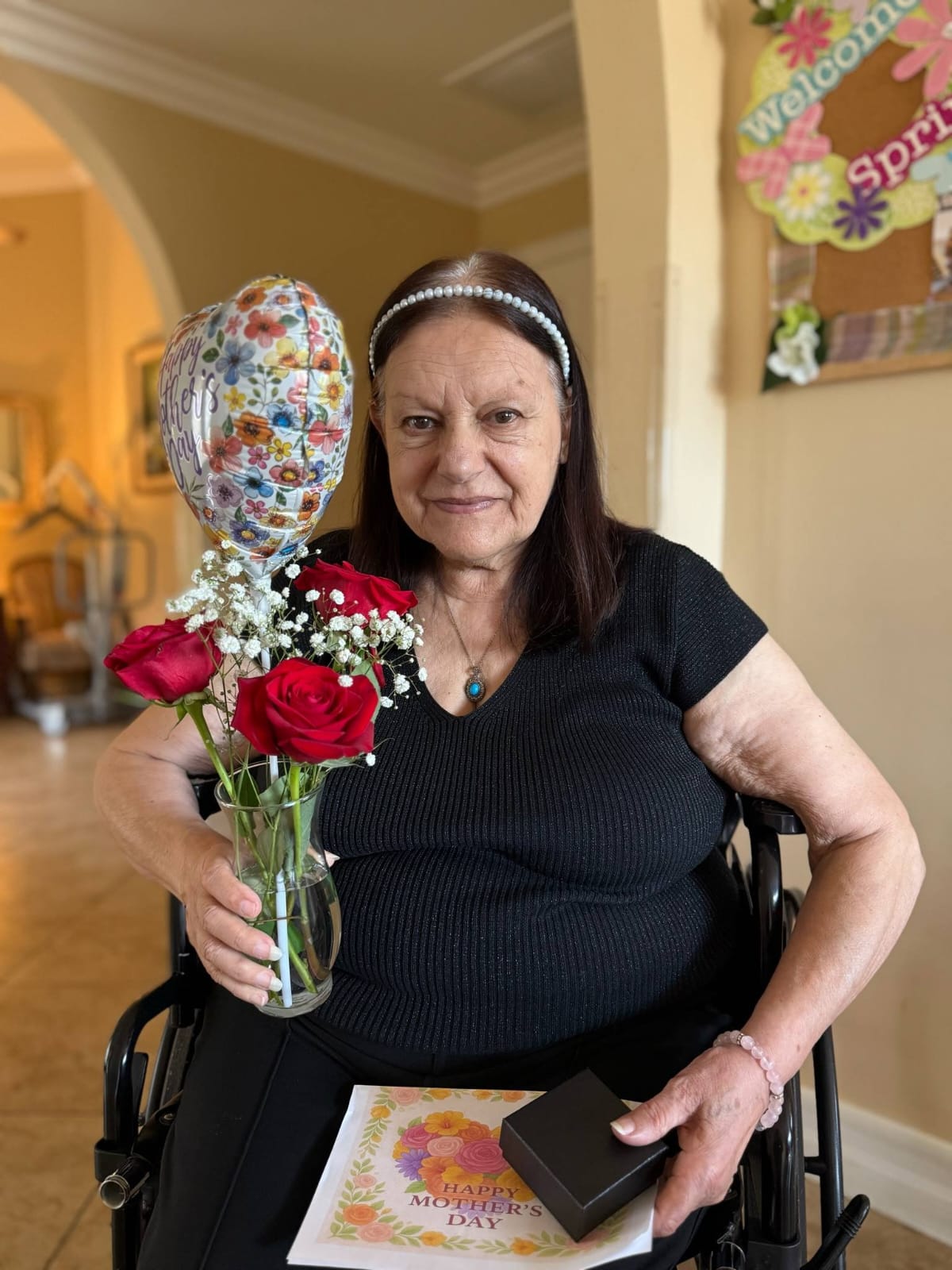 an elderly woman holding a flowers