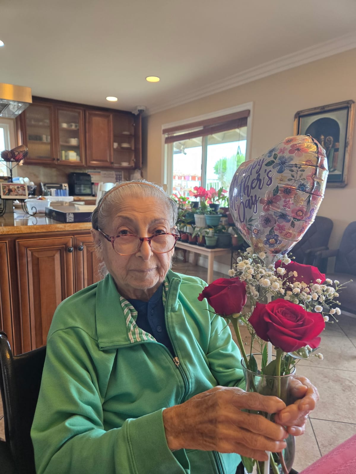 an elderly woman holding a flowers